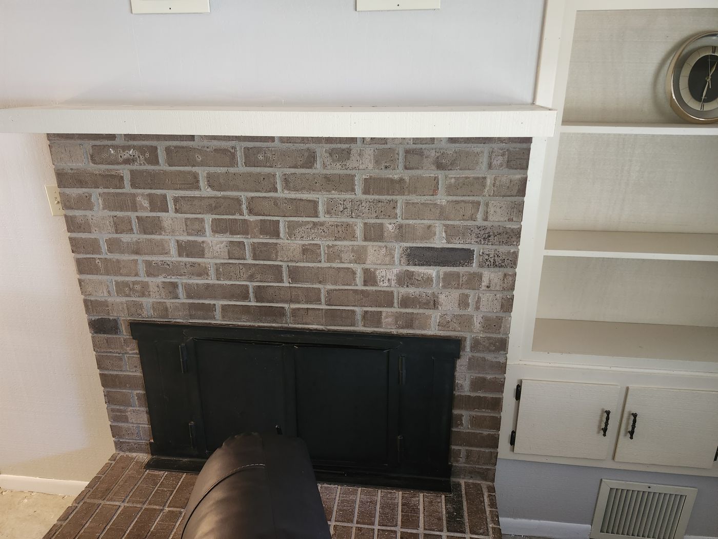 Painted brick fireplace and white built-ins from a Ventura Project Solutions project
